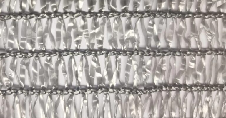 Detail of the fabric of a heat-diffusing mesh with Agrifresh aluminium for thermal control in greenhouses